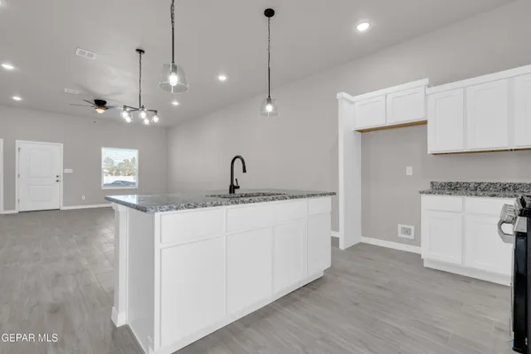 a kitchen with stainless steel appliances granite countertop a stove a sink and a refrigerator