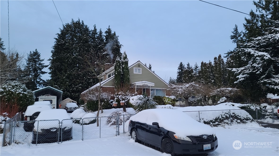 522 Northeast 127th Street Seattle, WA 98125 - Photo 1 of 28 a view of a white house with a yard and sitting area