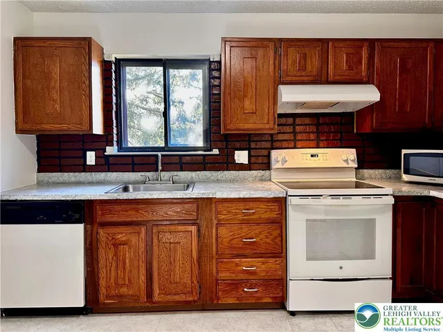 a kitchen with a refrigerator and cabinets