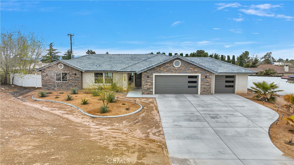 13968 Chogan Road Apple Valley, CA 92307 - Photo 1 of 35 a front view of a house with a yard and garage