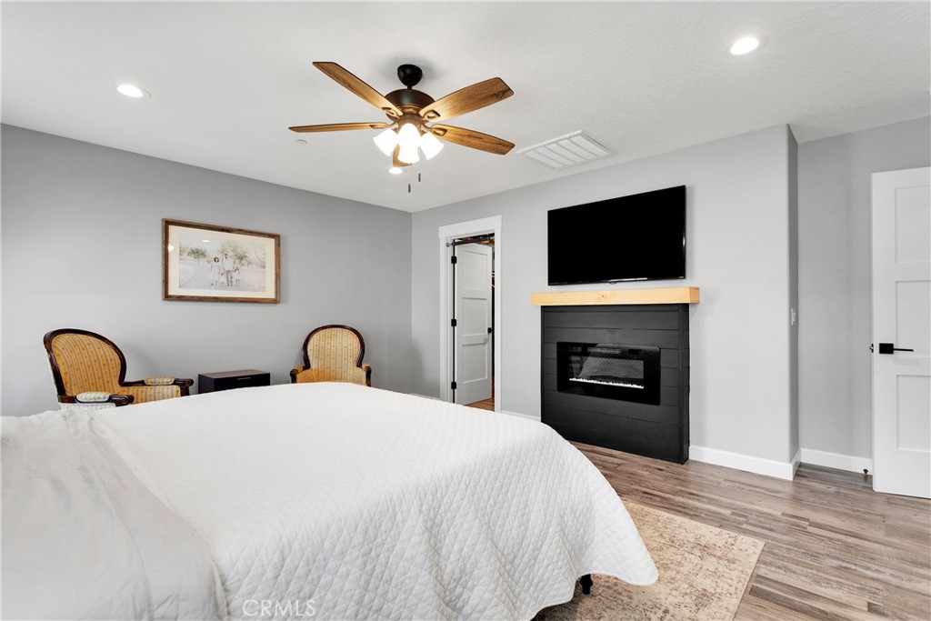 13968 Chogan Road Apple Valley, CA 92307 - Photo 16 of 35 a bedroom with a bed and a flat screen tv