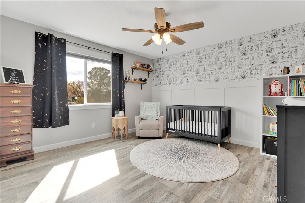 13968 Chogan Road Apple Valley, CA 92307 - Photo 19 of 35 a bedroom with furniture and window