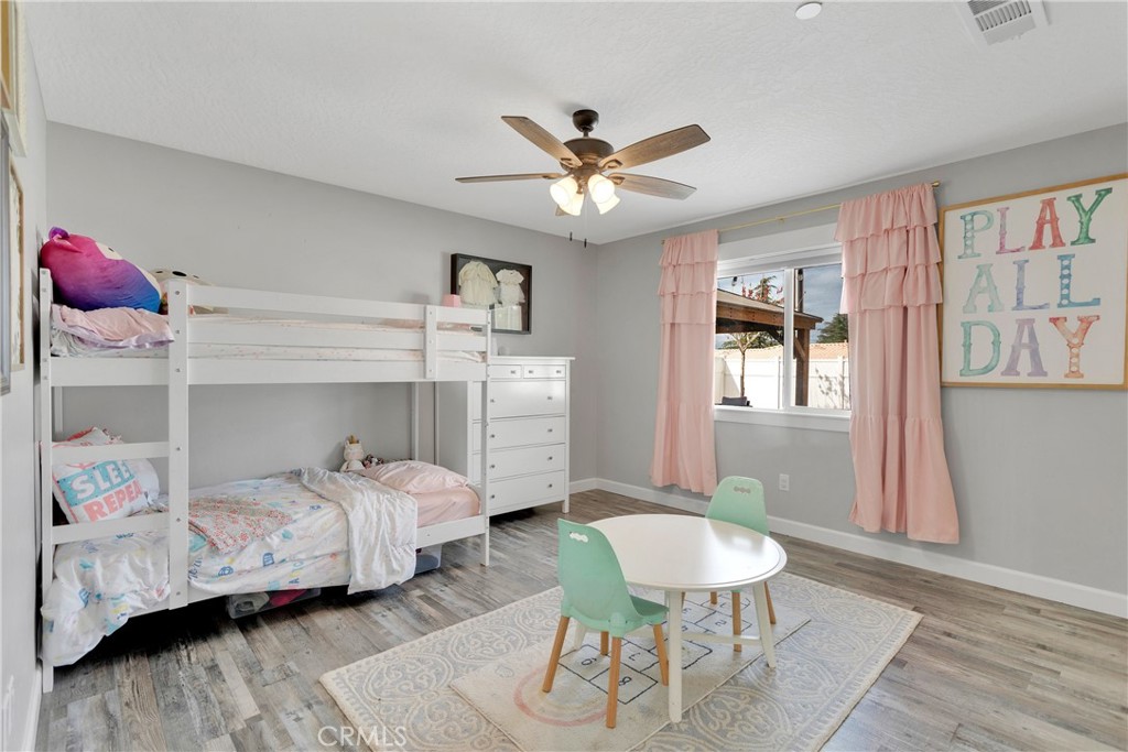 13968 Chogan Road Apple Valley, CA 92307 - Photo 20 of 35 a bedroom with a bed and a table in it