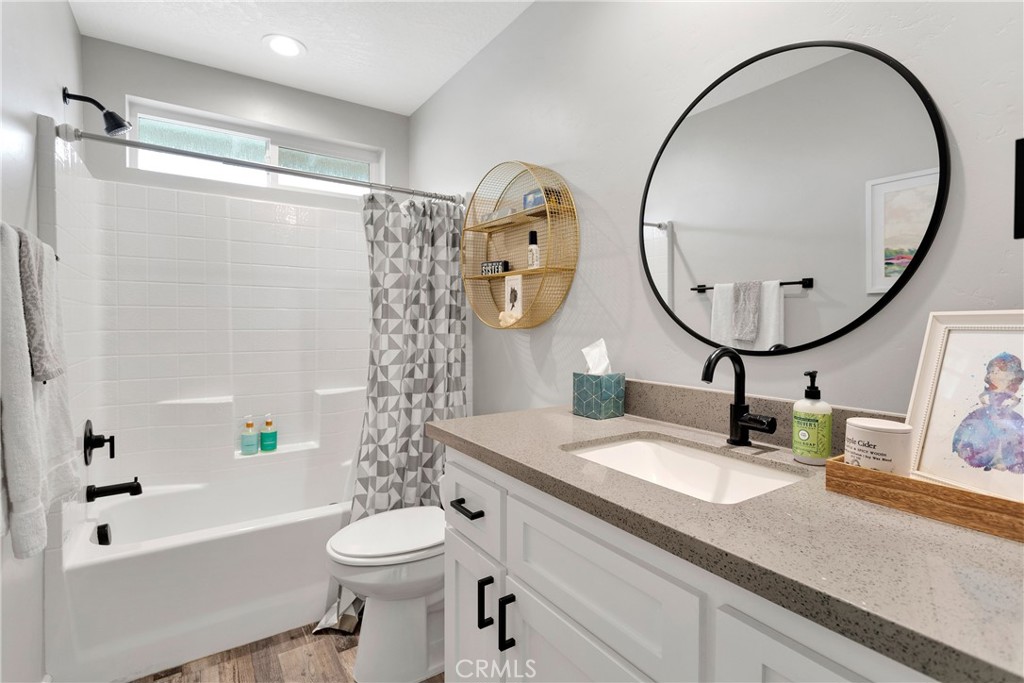 13968 Chogan Road Apple Valley, CA 92307 - Photo 22 of 35 a bathroom with a sink a toilet and a mirror