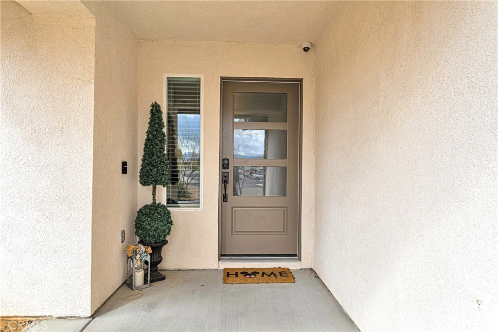 13968 Chogan Road Apple Valley, CA 92307 - Photo 3 of 35 a room with chair and a potted plant