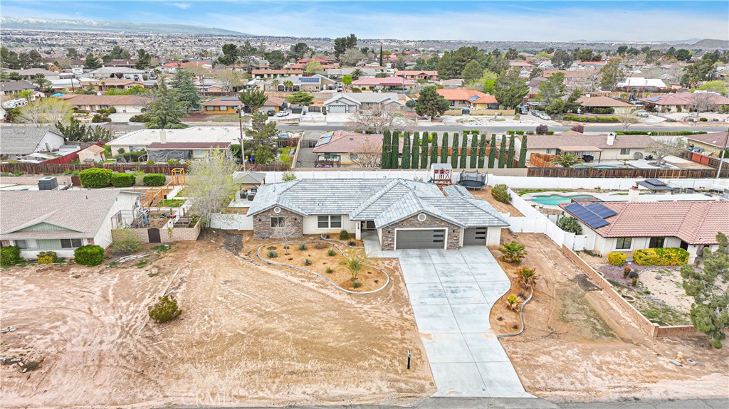 13968 Chogan Road Apple Valley, CA 92307 - Photo 32 of 35 an aerial view of a house with a swimming pool