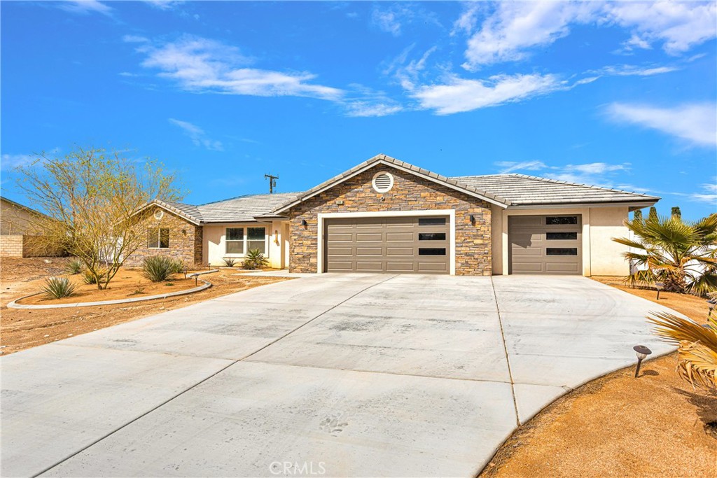 13968 Chogan Road Apple Valley, CA 92307 - Photo 33 of 35 a big house with a big yard and large trees