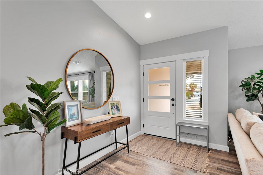 13968 Chogan Road Apple Valley, CA 92307 - Photo 4 of 35 a living room with furniture a potted plant and a wooden floor