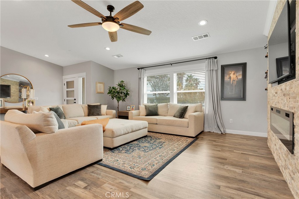 13968 Chogan Road Apple Valley, CA 92307 - Photo 7 of 35 a living room with furniture fireplace and a window