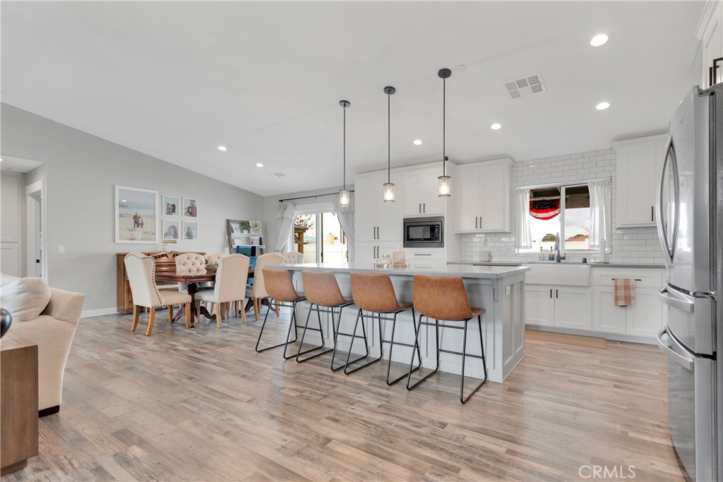13968 Chogan Road Apple Valley, CA 92307 - Photo 8 of 35 a large kitchen with a table and chairs