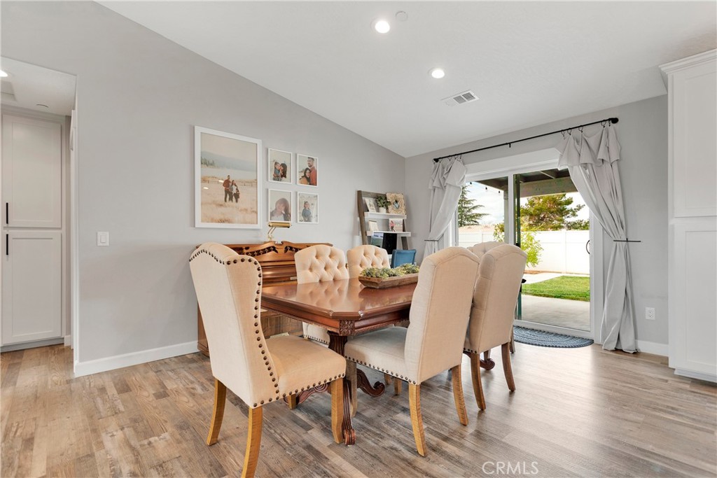 13968 Chogan Road Apple Valley, CA 92307 - Photo 9 of 35 a view of a dining room with furniture and wooden floor