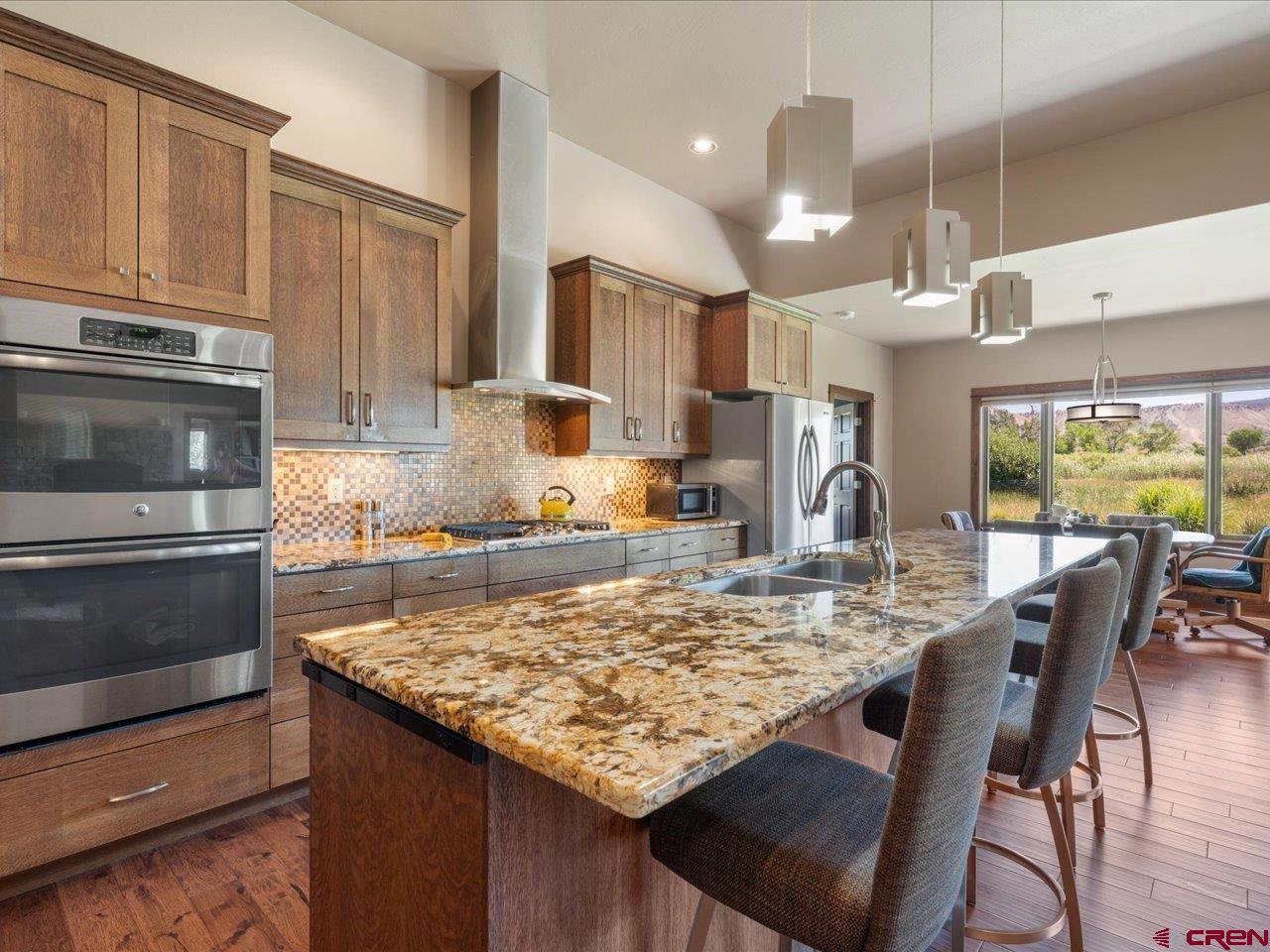 20784 6840th Road Montrose, CO 81403 - Photo 11 of 35 a kitchen with stainless steel appliances granite countertop a stove top oven a sink refrigerator and cabinets