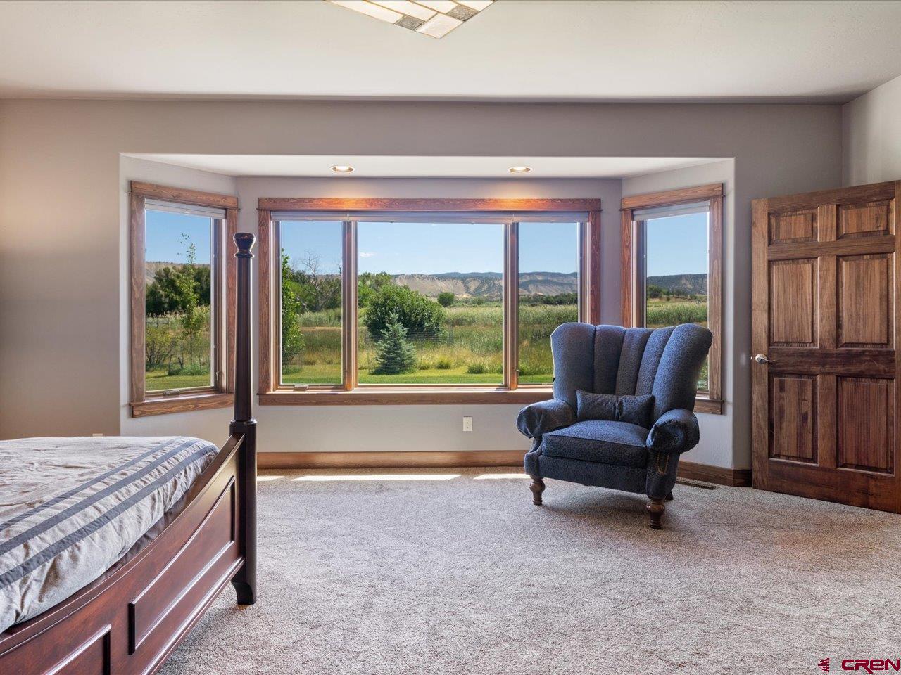 20784 6840th Road Montrose, CO 81403 - Photo 22 of 35 a living room with furniture and a floor to ceiling window