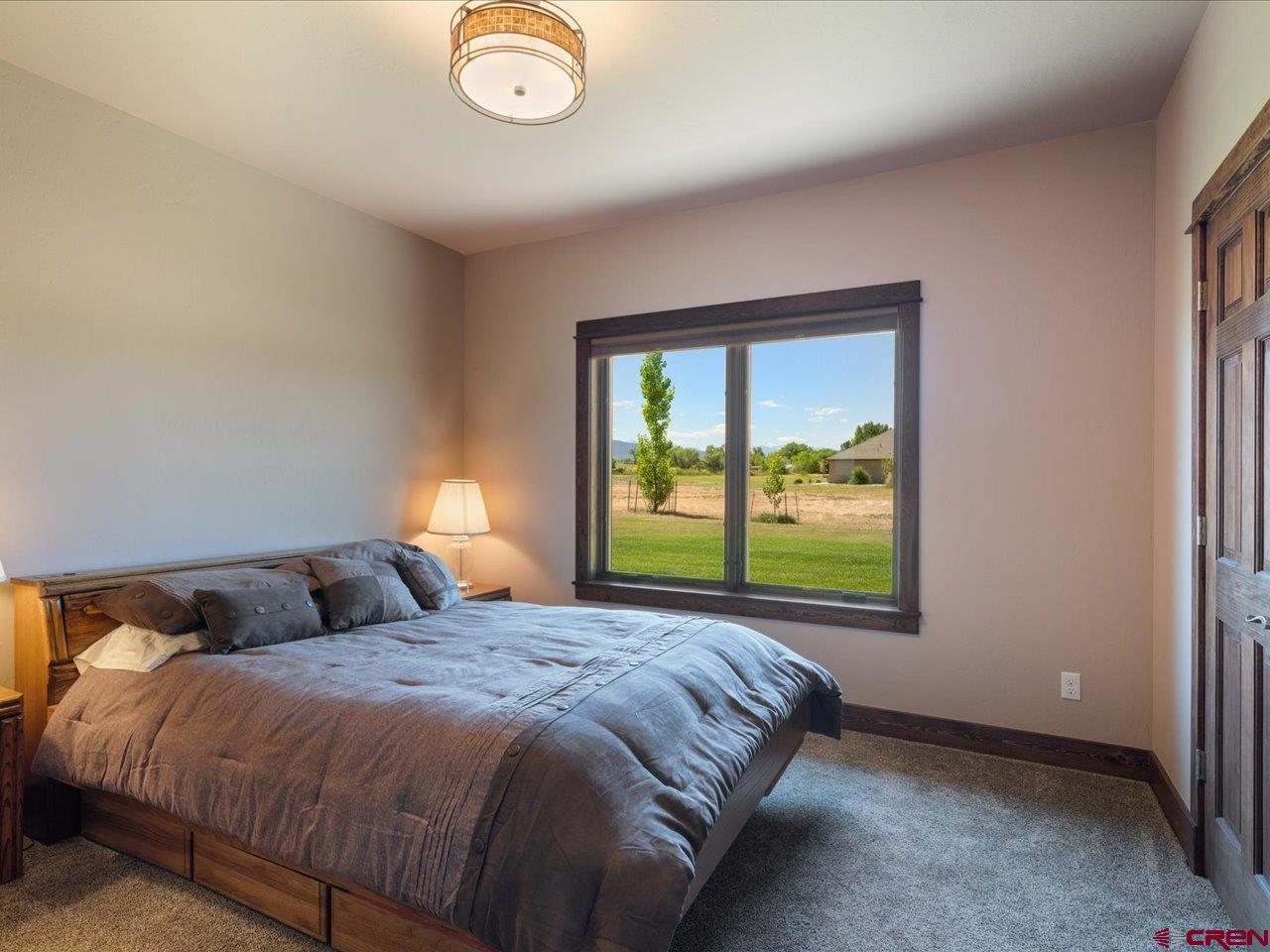 20784 6840th Road Montrose, CO 81403 - Photo 27 of 35 a bed sitting in a bedroom next to a window
