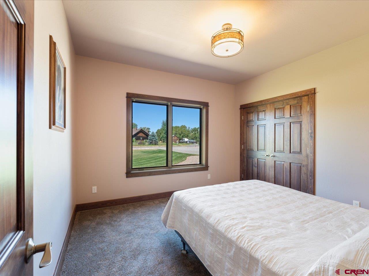 20784 6840th Road Montrose, CO 81403 - Photo 30 of 35 a bedroom with a bed and a window