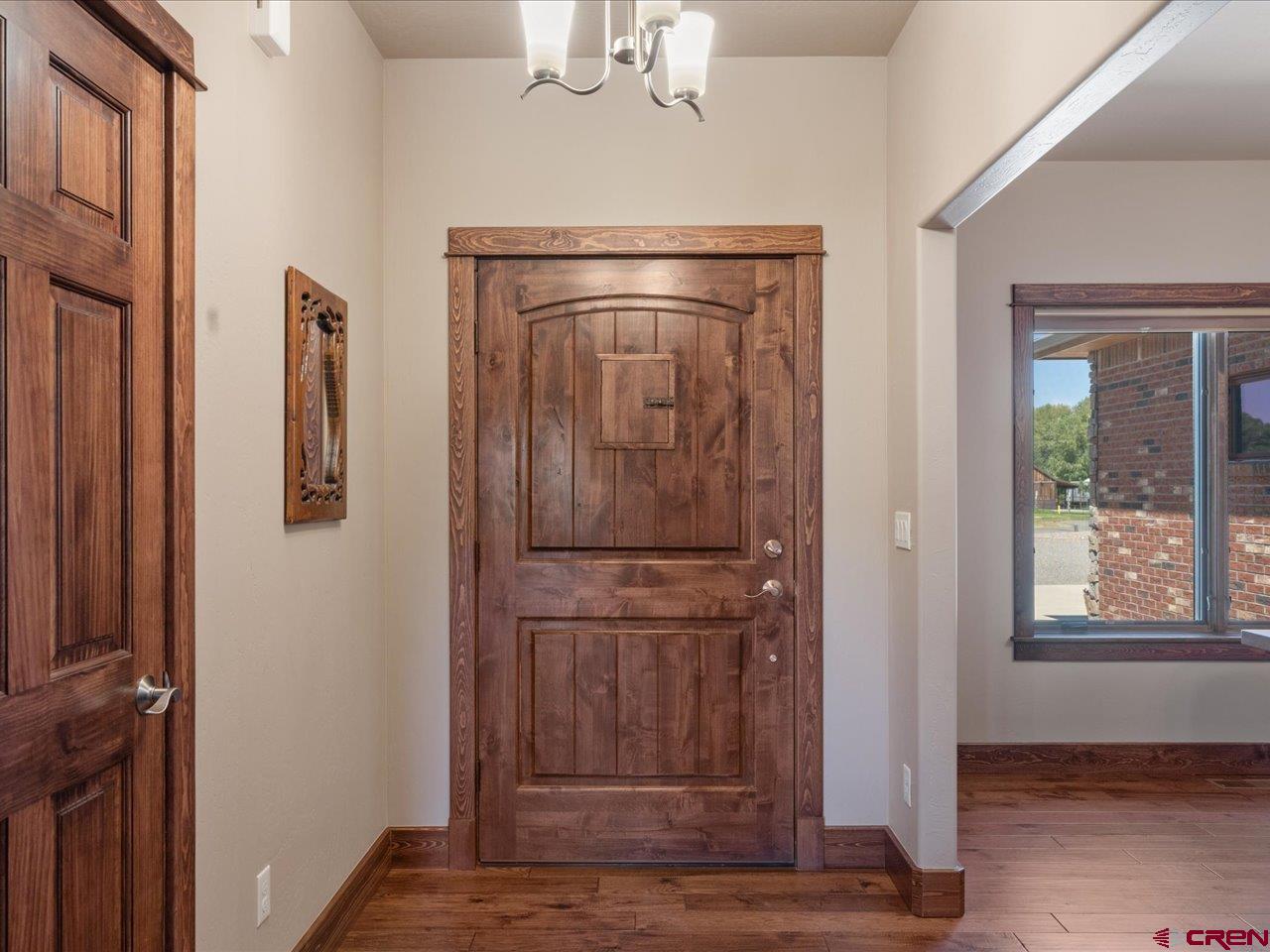 20784 6840th Road Montrose, CO 81403 - Photo 5 of 35 a view of a hallway with wooden floor and cabinet