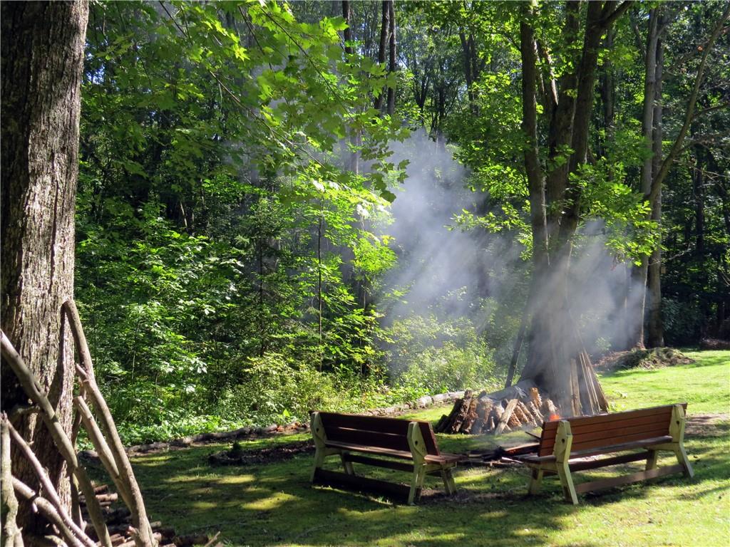 2056 Prospect Road Prospect, PA 16052 - Photo 7 of 25 a view of swimming pool with lawn chairs and a fire pit