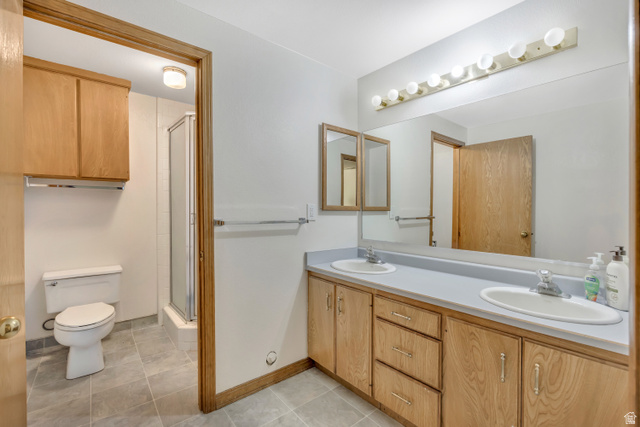 887 Village Way Alpine, UT 84004 - Photo 25 of 28 Full bath featuring double vanity, a stall shower, and light tile patterned flooring