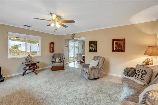 a view of a dining room with furniture a chandelier and wooden floor