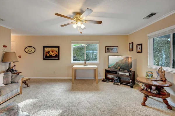 a spacious bedroom with a bed and a chandelier