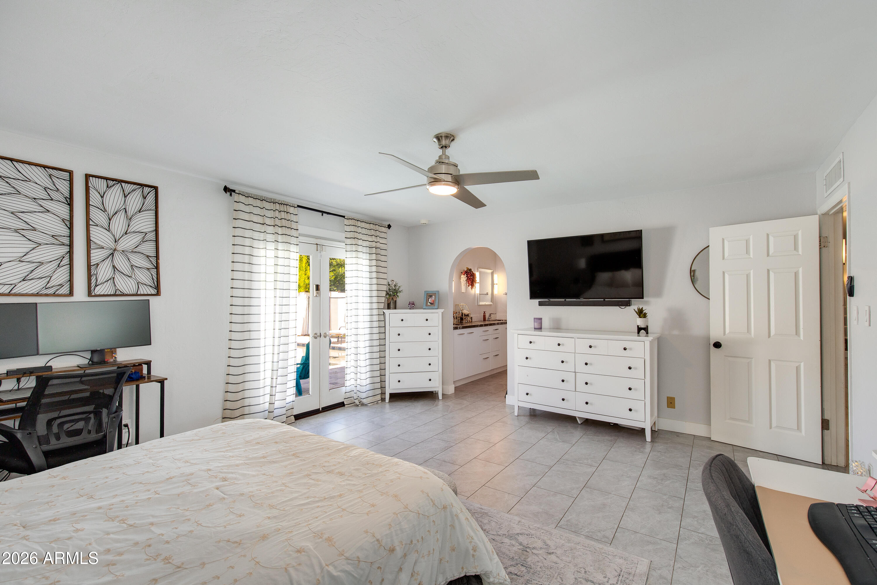 8219 North 3rd Avenue Phoenix, AZ 85021 - Photo 30 of 52 a bedroom with a bed dresser and a flat tv screen