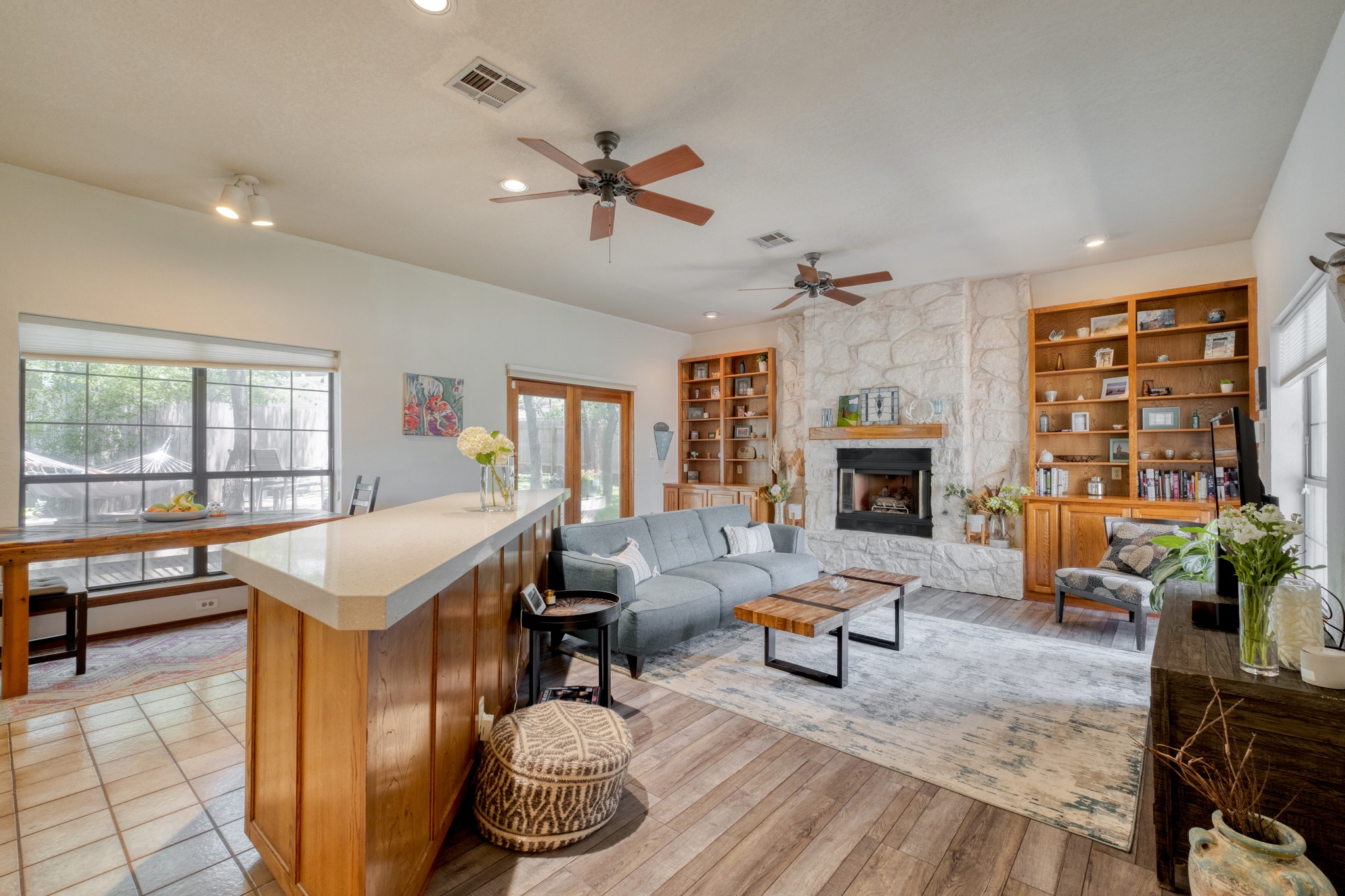 202 Ridgewood Drive Georgetown, TX 78628 - Photo 15 of 40 Spacious living area featuring a prominent stone-clad fireplace with a wood mantel, flanked by built-in wood shelving