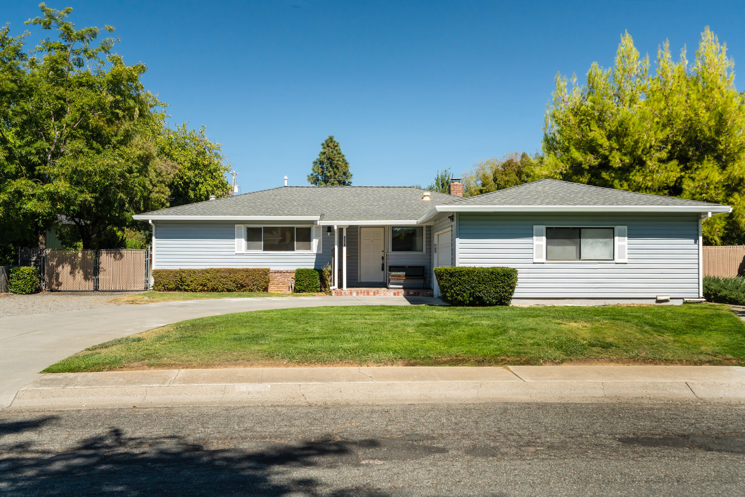 a front view of a house with a garden
