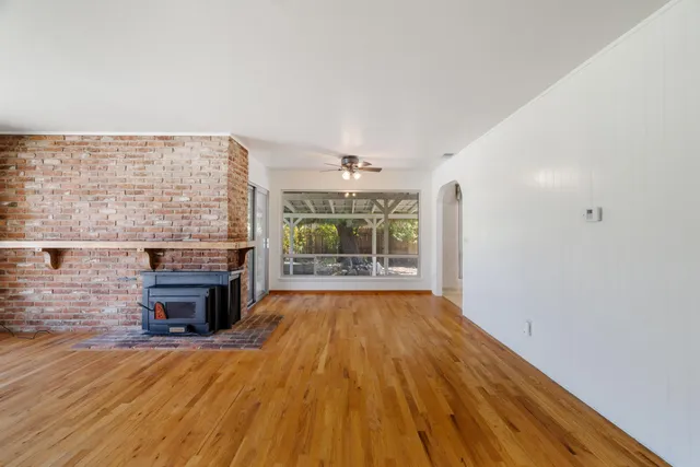 wooden floor in an empty room with a fireplace
