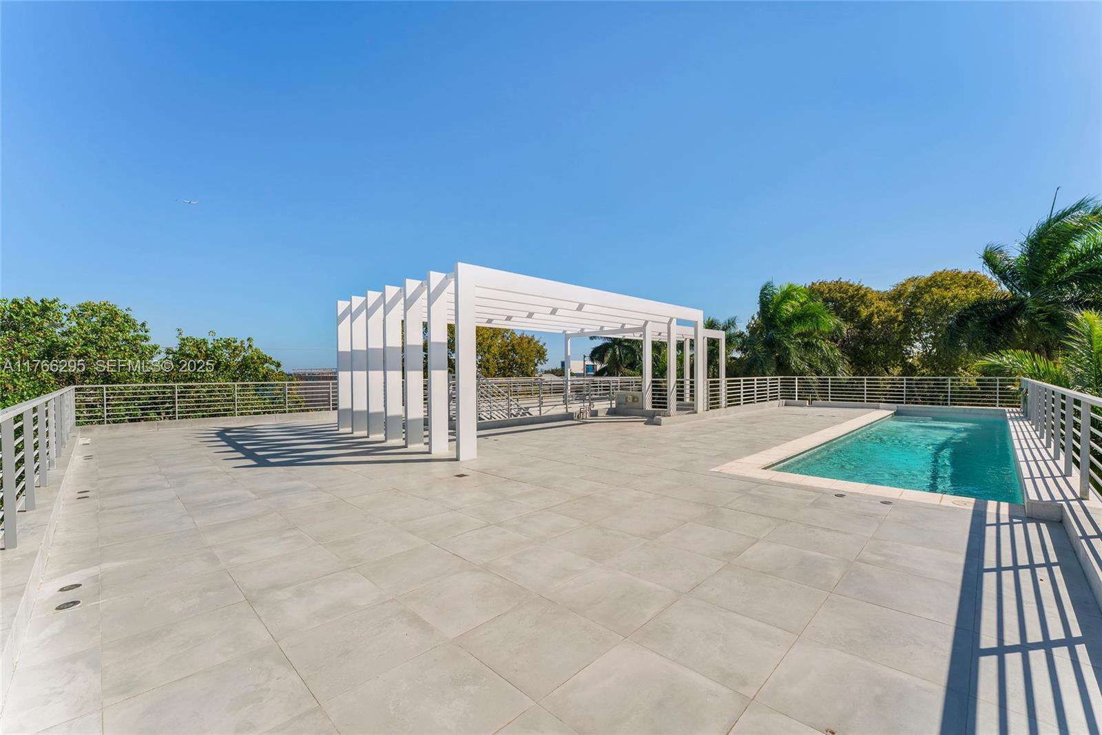 1250 North Venetian Way Miami, FL 33139 - Photo 11 of 61 a view of a swimming pool with an outdoor seating and a garden