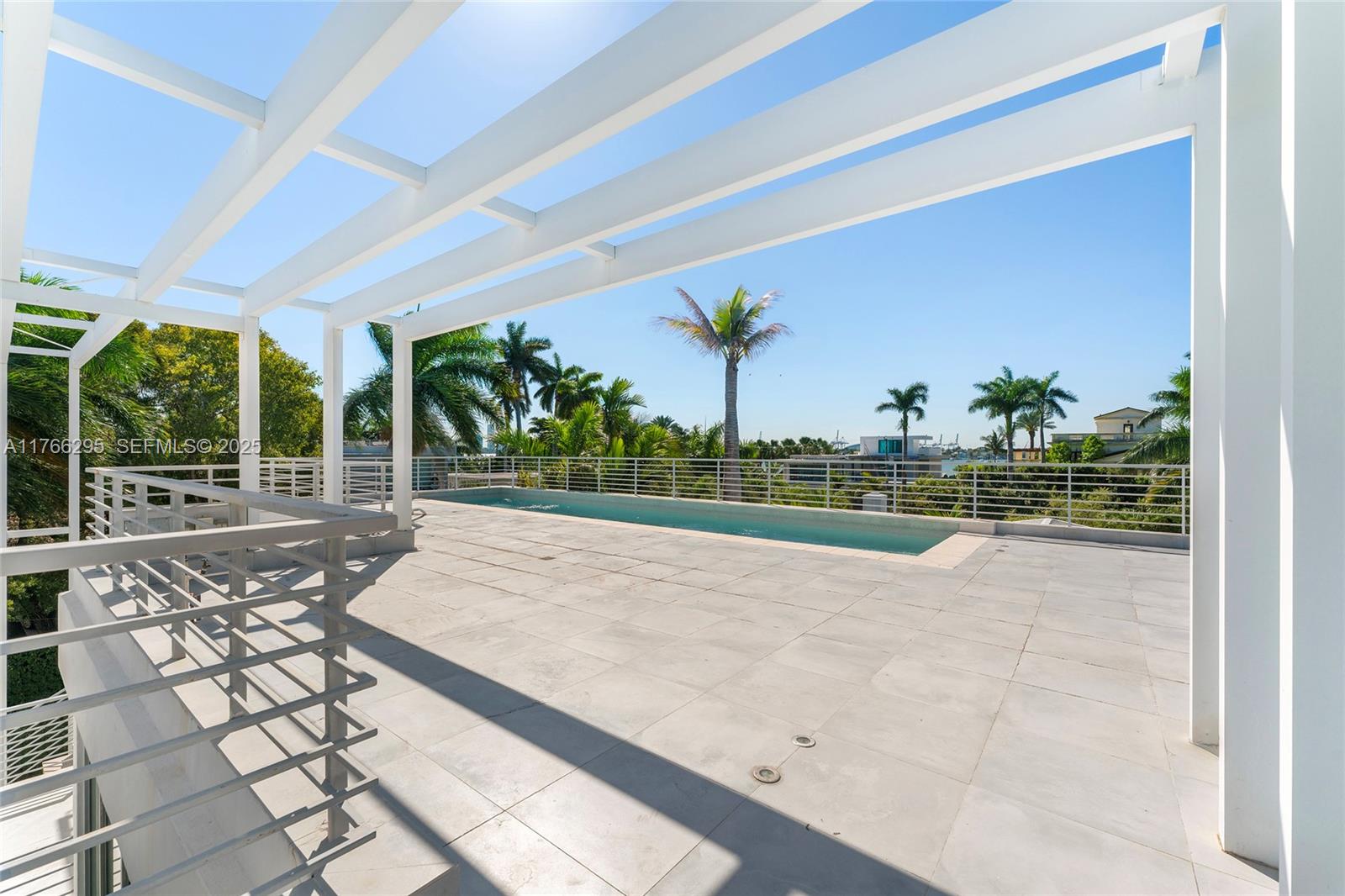 1250 North Venetian Way Miami, FL 33139 - Photo 15 of 61 a view of a swimming pool with a porch