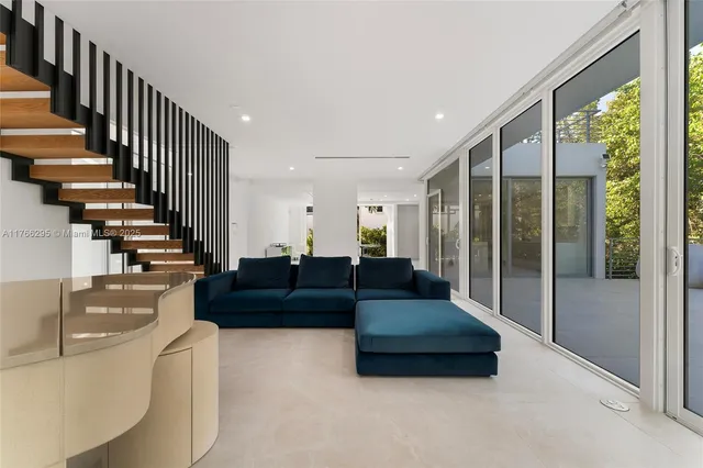 a dining room with furniture and a floor to ceiling window