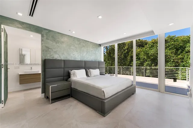 a spacious bedroom with a large bed and a large window