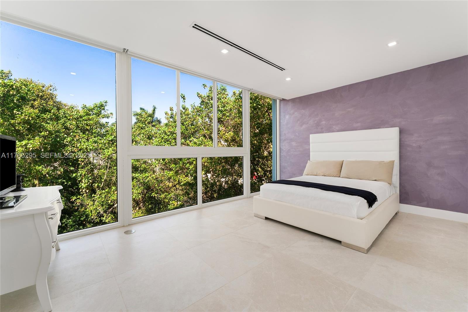 1250 North Venetian Way Miami, FL 33139 - Photo 36 of 61 a spacious bedroom with a large bed and a large window