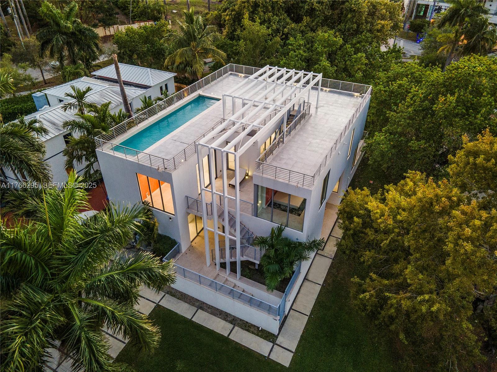 1250 North Venetian Way Miami, FL 33139 - Photo 5 of 61 a view of a house with a yard and potted plants