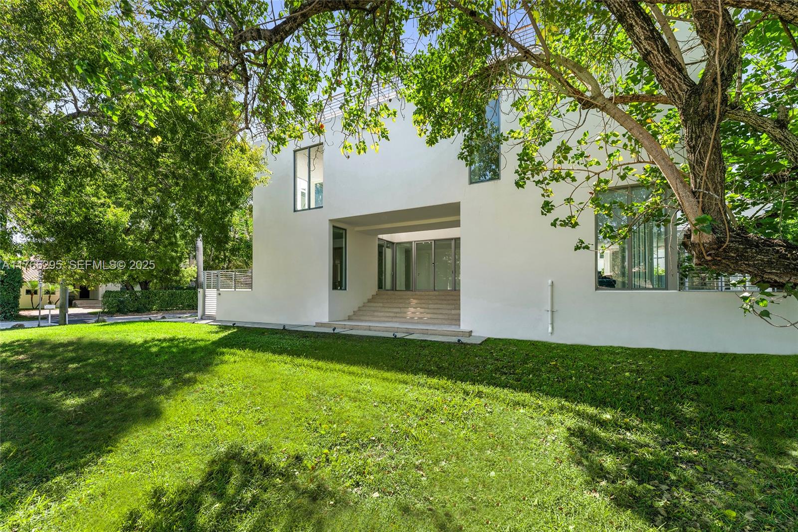 1250 North Venetian Way Miami, FL 33139 - Photo 7 of 61 a view of a house with a yard and a large tree
