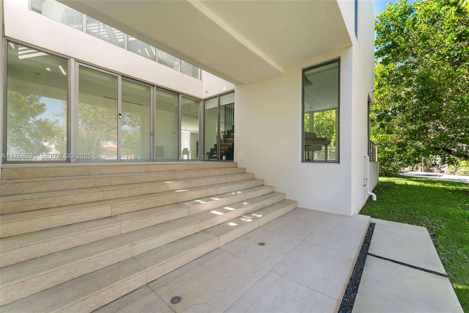 1250 North Venetian Way Miami, FL 33139 - Photo 8 of 61 a bedroom with a bed and a large window