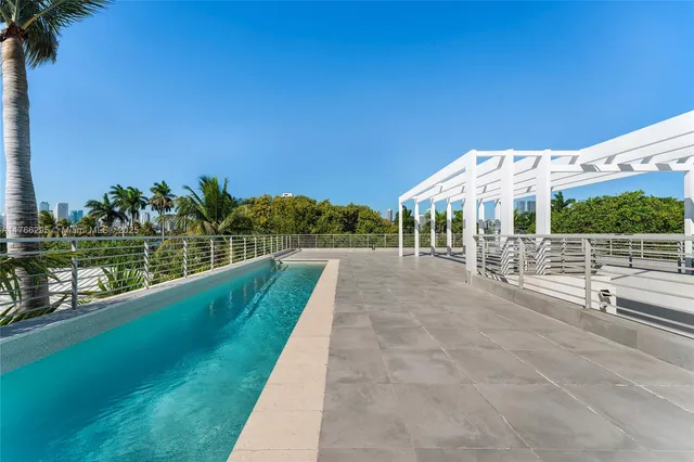 a view of a swimming pool with an outdoor seating and a garden