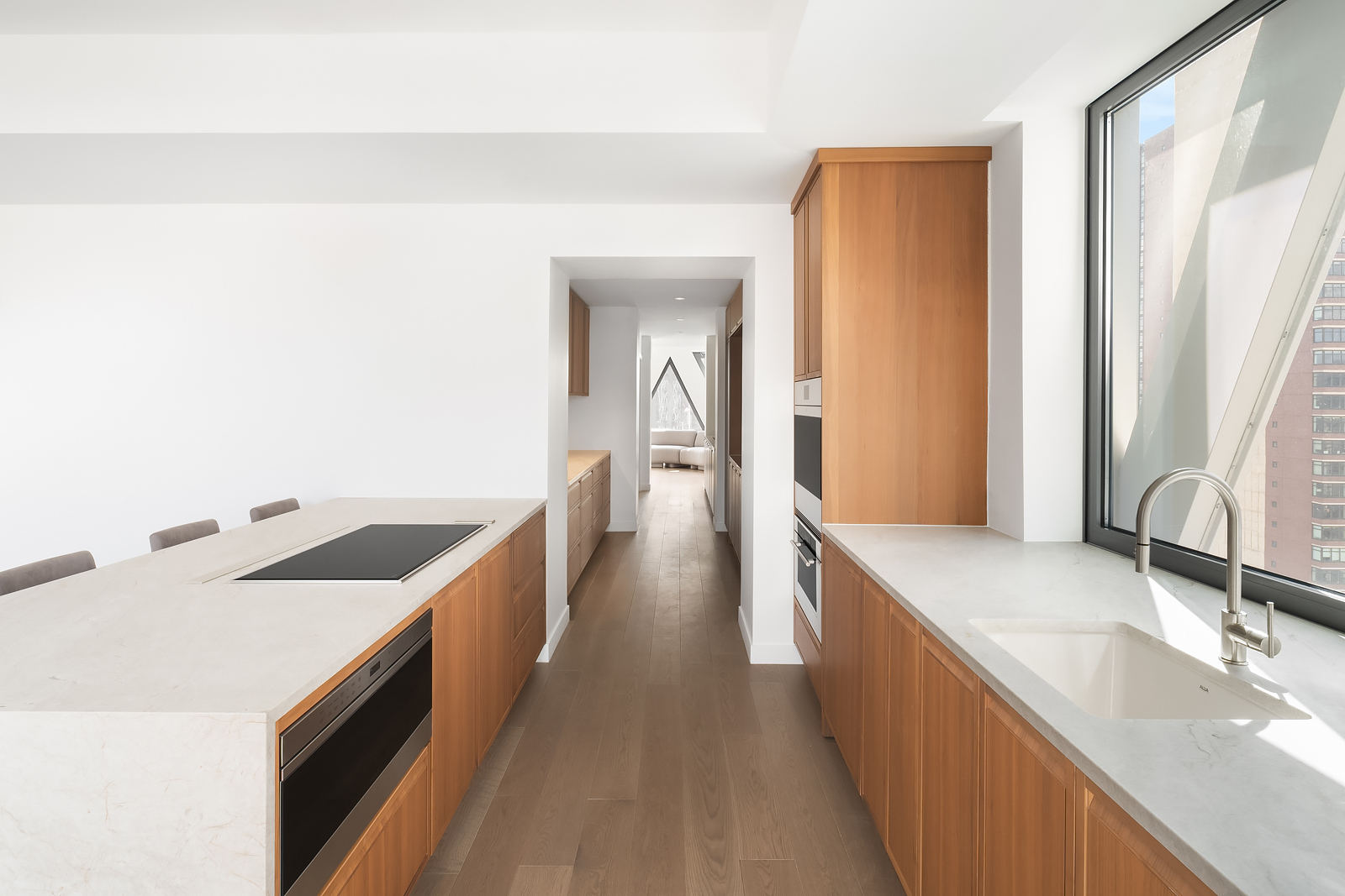 30 East 31st Street, Unit PH Manhattan, NY 10016 - Photo 4 of 10 a kitchen with granite countertop a sink stove and cabinets