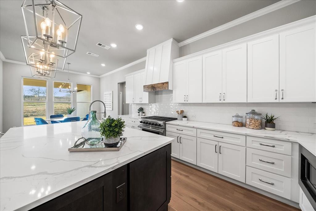 6421 Starlight Ranch Road Godley, TX 76044 - Photo 12 of 39 a kitchen with white cabinets and window