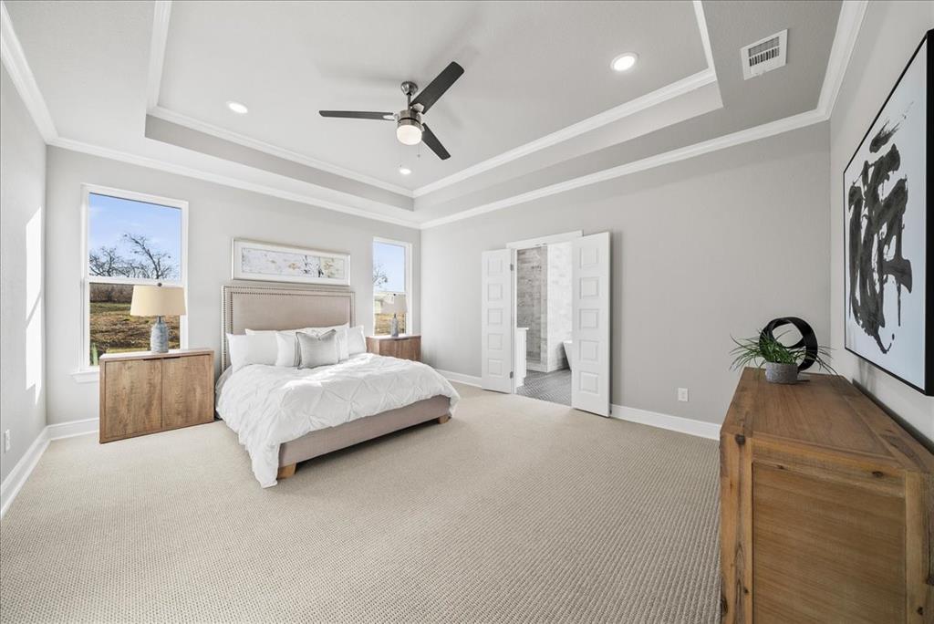 6421 Starlight Ranch Road Godley, TX 76044 - Photo 19 of 39 a spacious bedroom with a bed and a chandelier