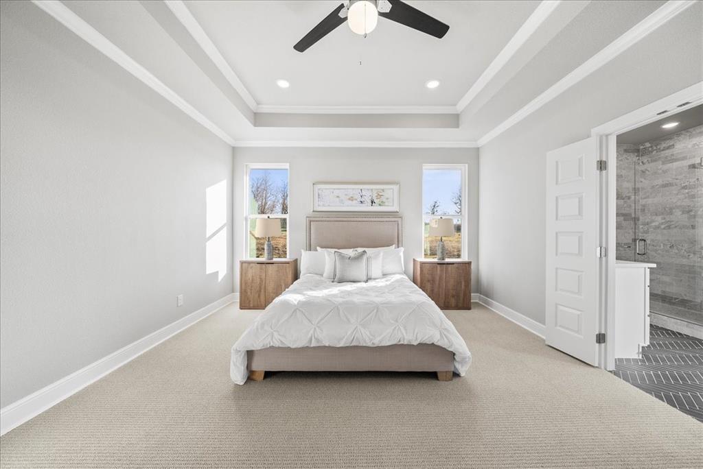 6421 Starlight Ranch Road Godley, TX 76044 - Photo 20 of 39 a spacious bedroom with a bed and ceiling fan