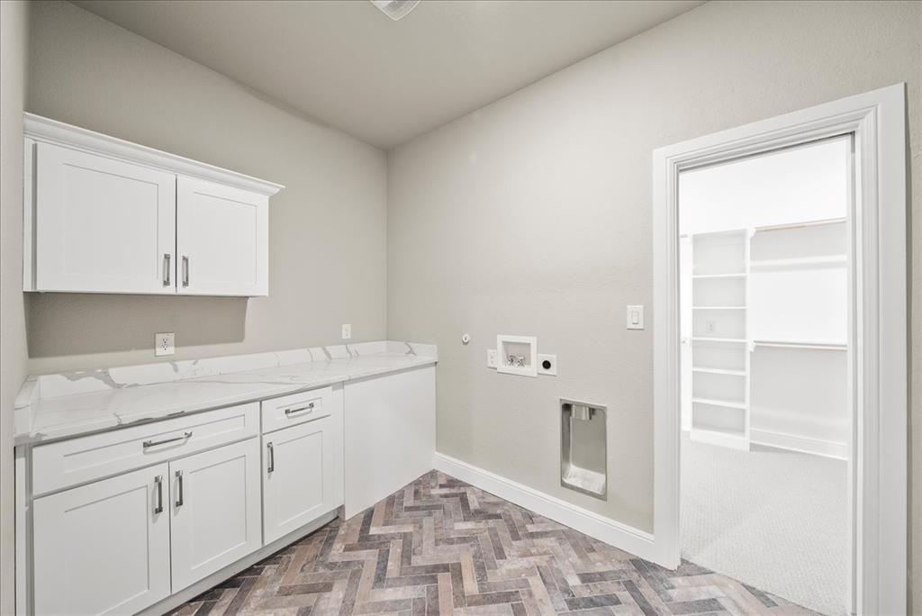 6421 Starlight Ranch Road Godley, TX 76044 - Photo 26 of 39 a spacious bathroom with a granite countertop sink and a mirror