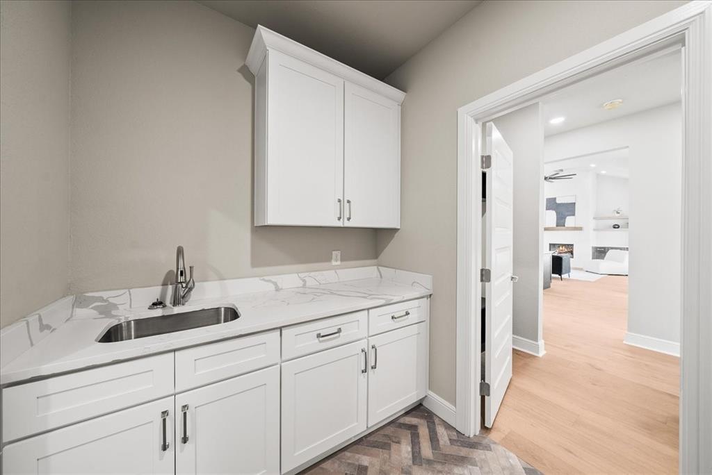 6421 Starlight Ranch Road Godley, TX 76044 - Photo 27 of 39 a kitchen with a sink and cabinets