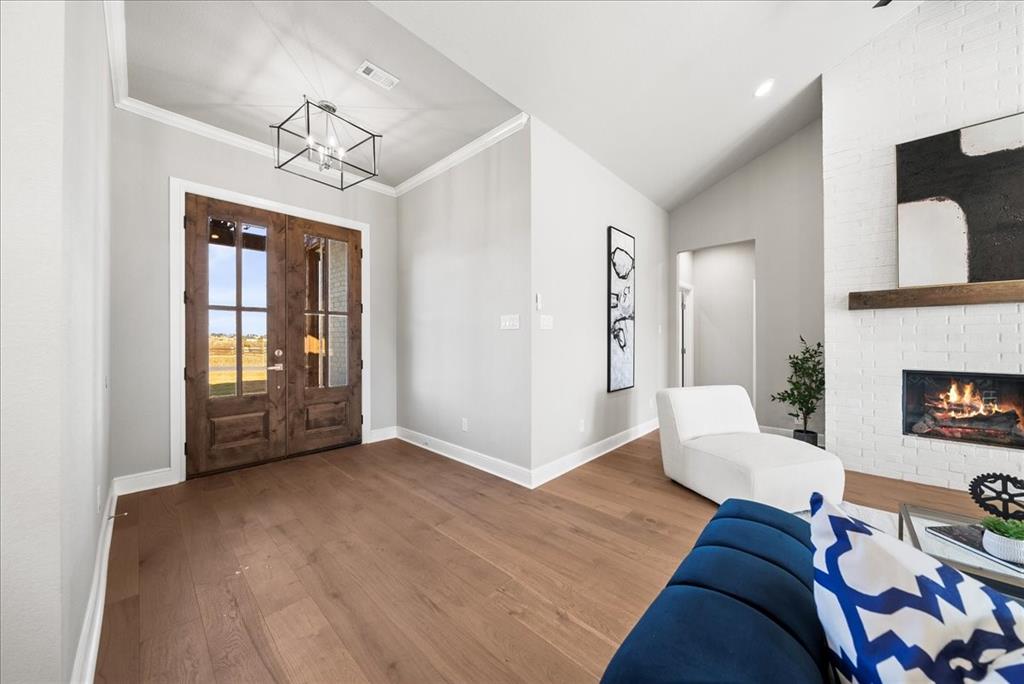 6421 Starlight Ranch Road Godley, TX 76044 - Photo 3 of 39 a living room with furniture and a chandelier
