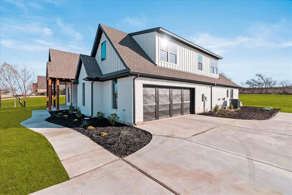 6421 Starlight Ranch Road Godley, TX 76044 - Photo 39 of 39 a front view of a house with a yard and garage
