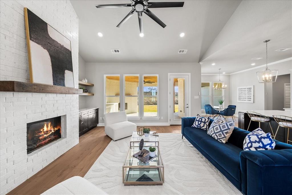 6421 Starlight Ranch Road Godley, TX 76044 - Photo 6 of 39 a living room with furniture and a fireplace