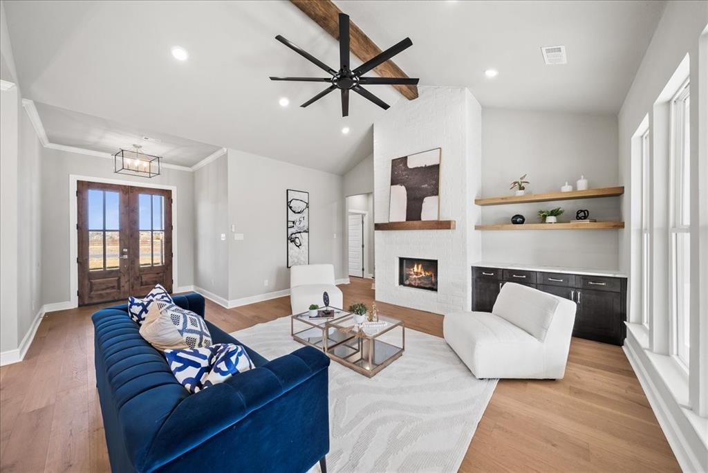 6421 Starlight Ranch Road Godley, TX 76044 - Photo 8 of 39 a living room with furniture fireplace and a window