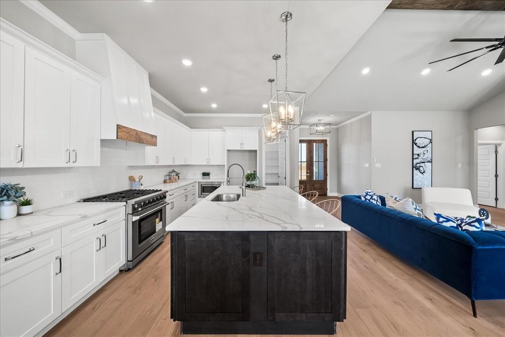 6421 Starlight Ranch Road Godley, TX 76044 - Photo 10 of 39 a large kitchen with kitchen island a sink stainless steel appliances and cabinets