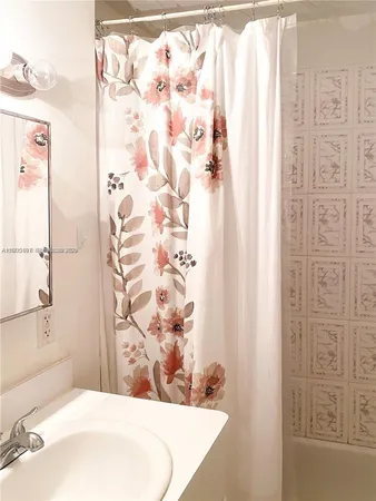 a bathroom with a bathtub and shower