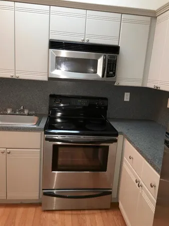 a stove top oven sitting inside of a kitchen